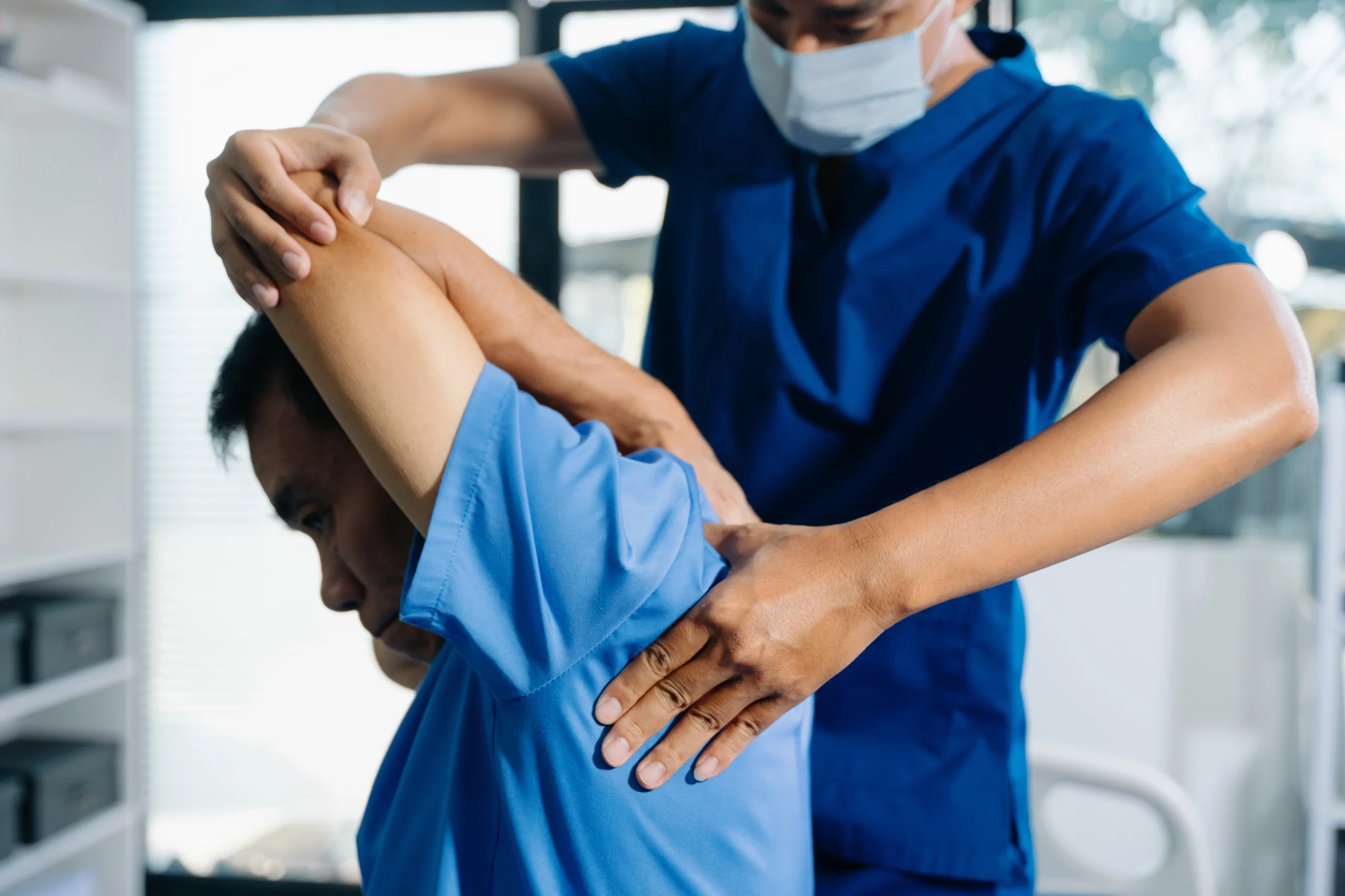medical-professional-treating-patient-with-arm-exe