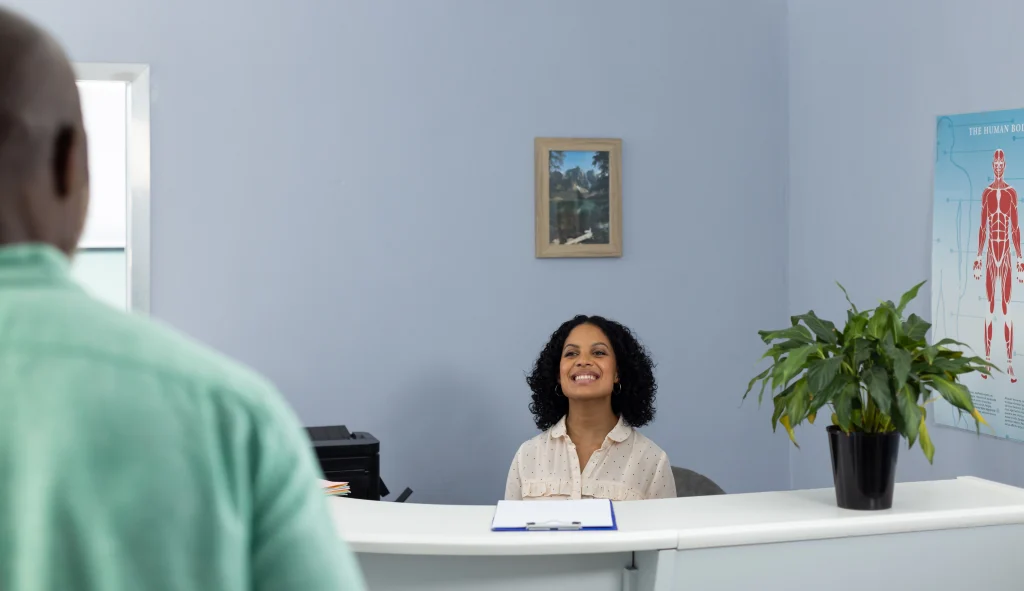 smiling-receptionist-at-medical-clinic-greets-patient